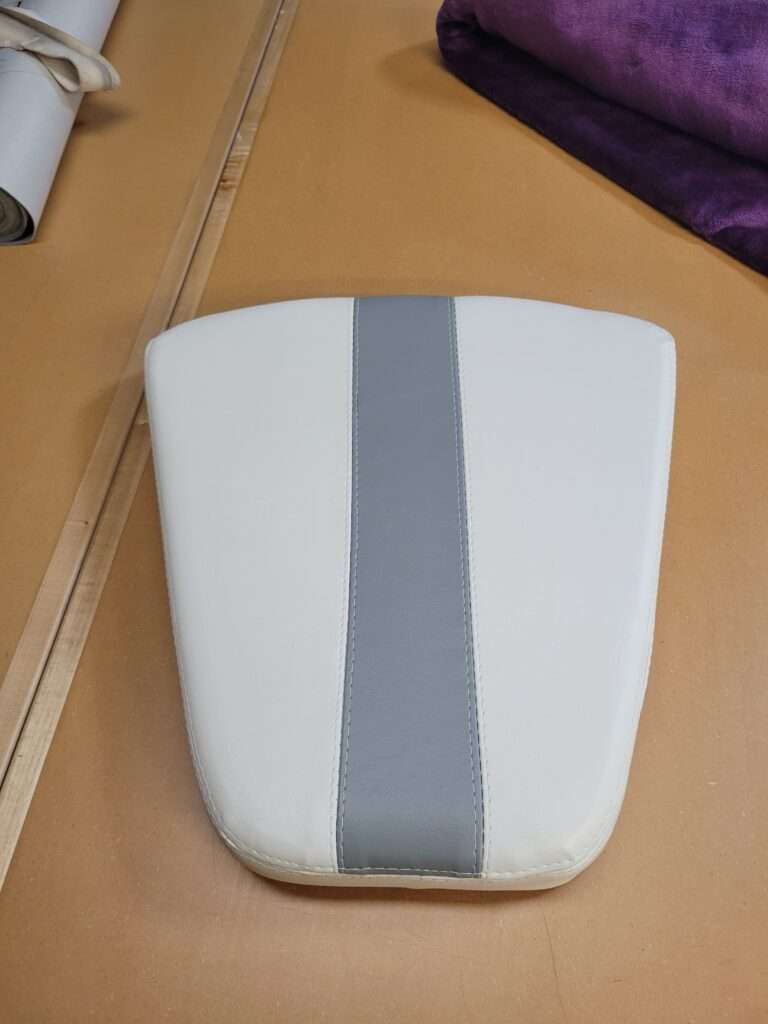 Close-up of new marine-grade vinyl stitching on a reupholstered boat cushion