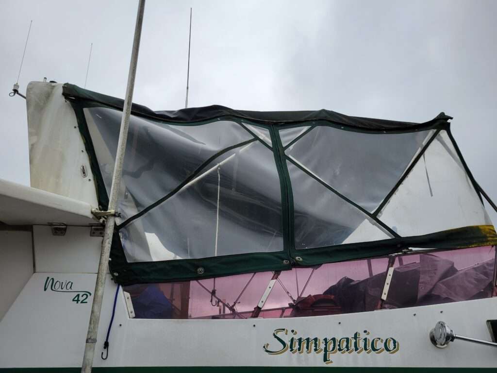 Before: aged, hazy bow enclosure on a cruiser