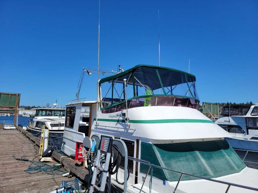 Custom green flybridge canvas enclosure with clear vinyl panels on a motor yacht, Lake Washington marina