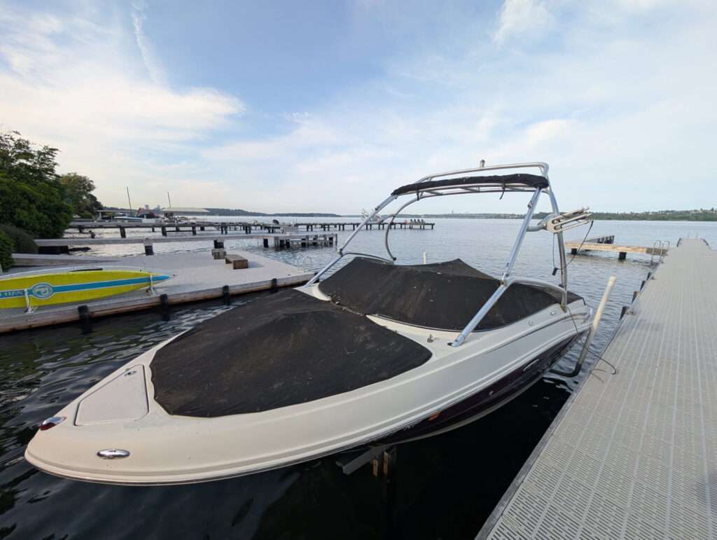 Snug-fitting black snap-on cockpit cover on a bowrider
