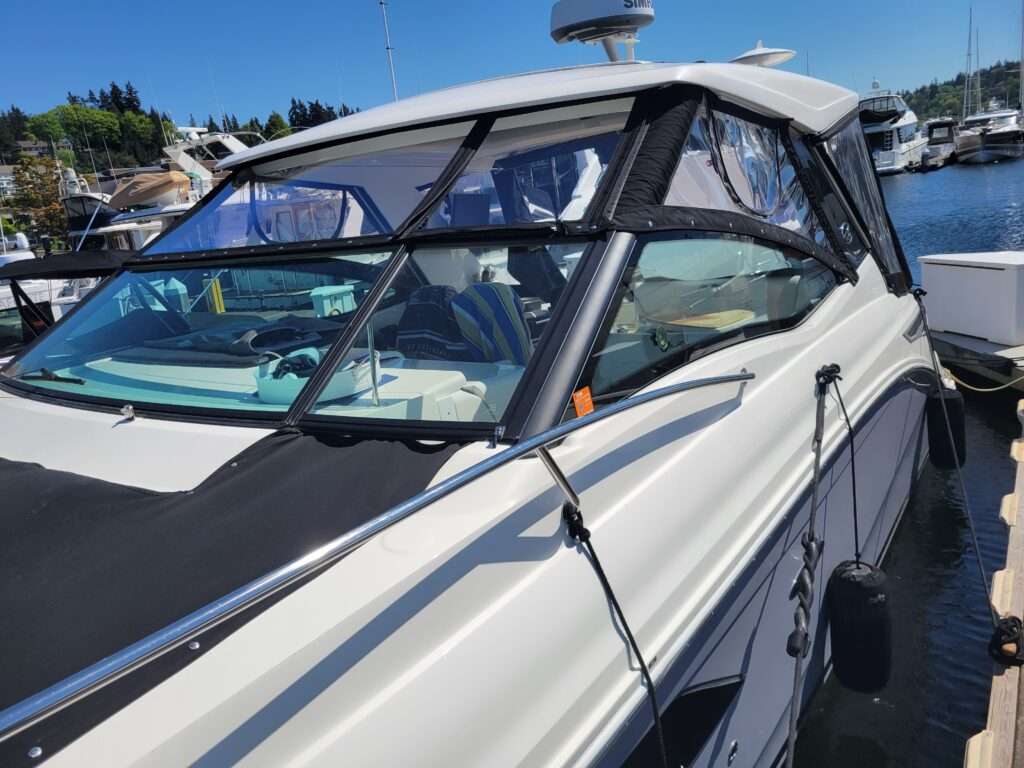 Black canvas enclosure with clear vinyl windows on an express cruiser