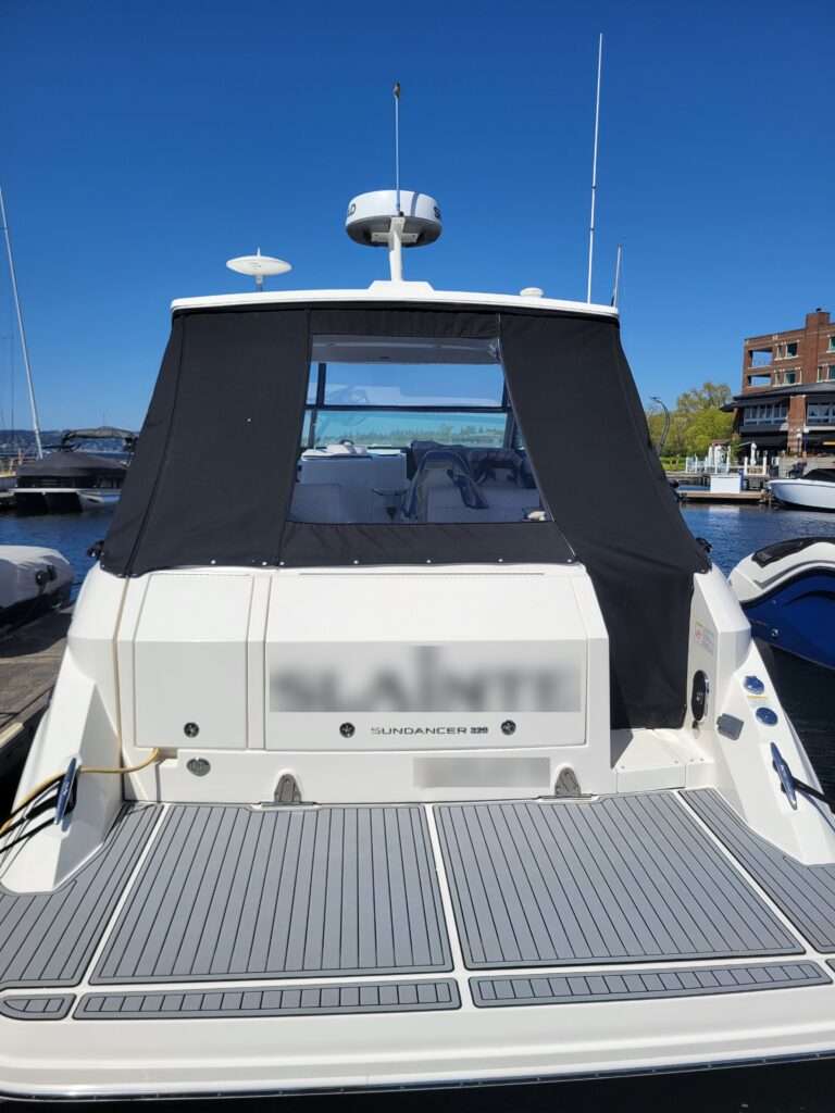 Custom black aft canvas enclosure on an express cruiser