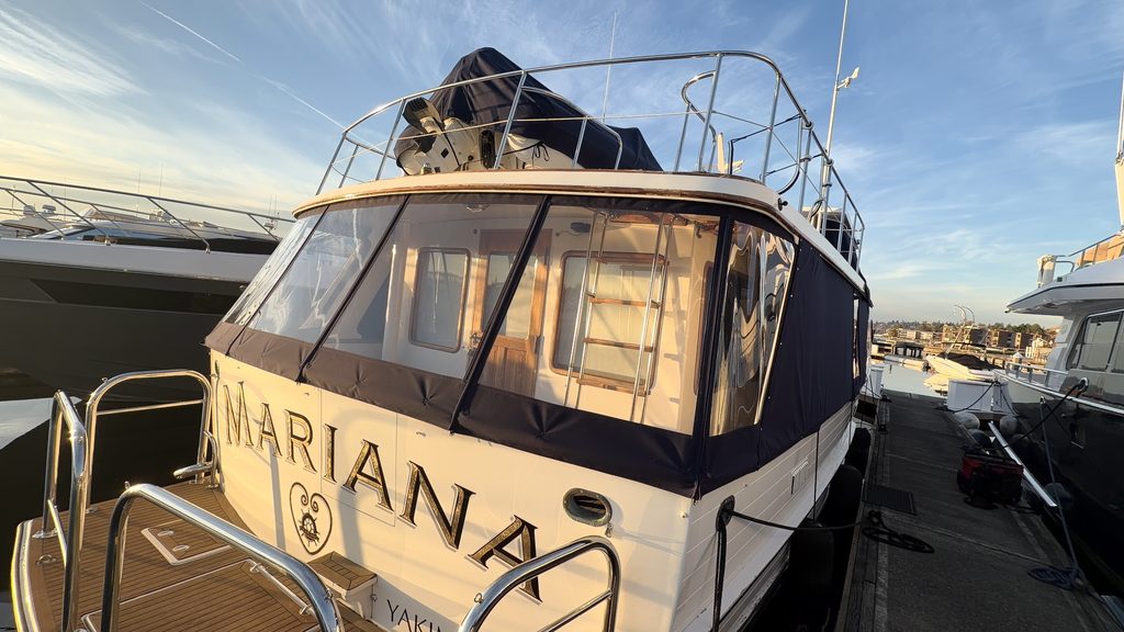 Custom navy canvas aft enclosure with clear windows on motor yacht Mariana, built by Williams Quality Covers in Kirkland, WA